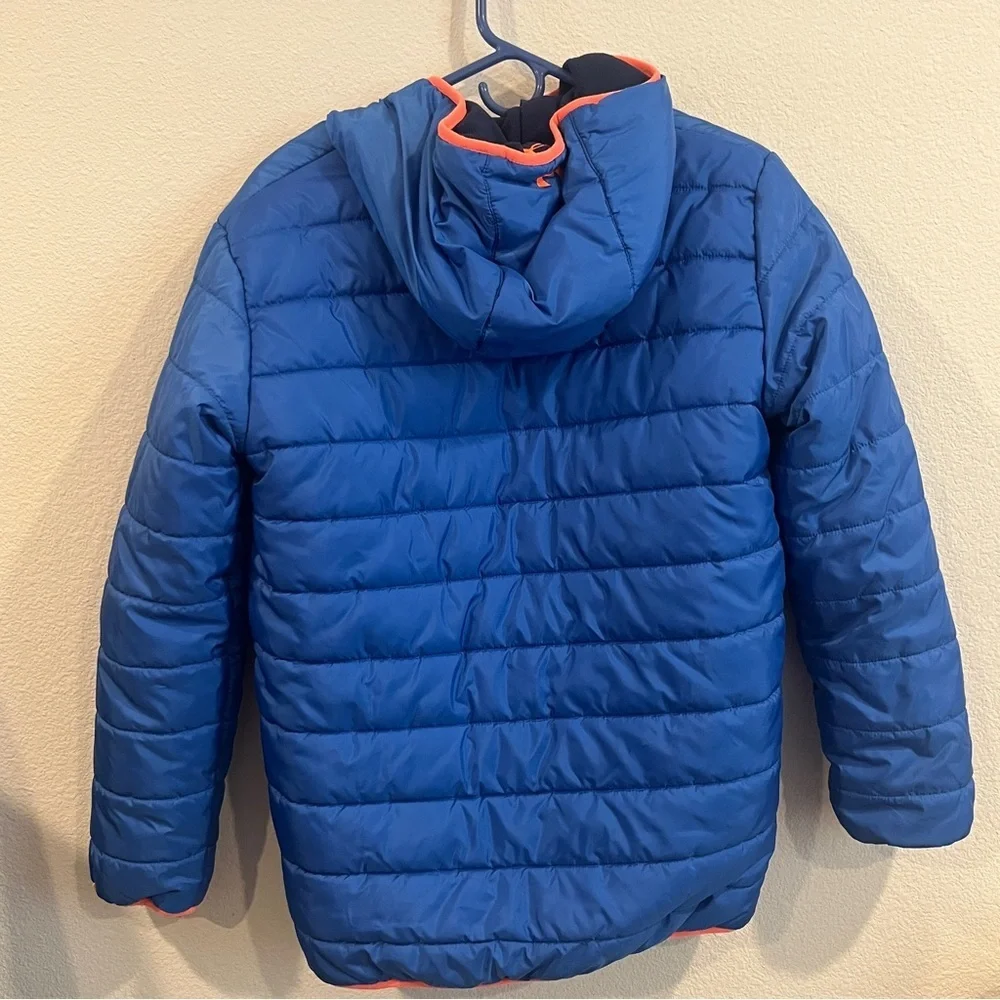 Under Armour kids size X-Large blue and orange reversible puffer jacket hooded